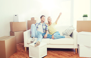 Image showing couple with boxes moving to new home and dreaming