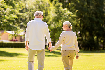 Image showing happy senior couple walking at summer park