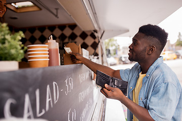 Image showing african american man buying wok at food truck