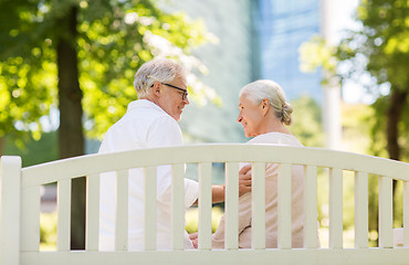 Image showing happy senior couple sitting on bench at park