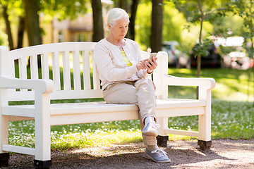 Image showing senior woman with smartphone at summer park