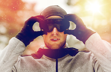 Image showing sports man with ski goggles in winter outdoors