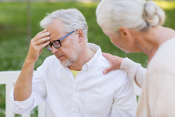 Image showing senior man suffering from headache outdoors