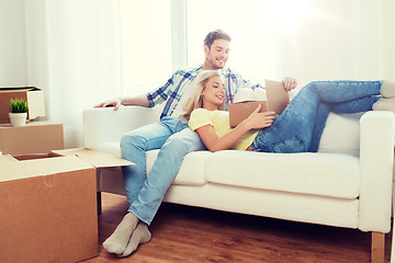 Image showing happy couple with big cardboard boxes at new home