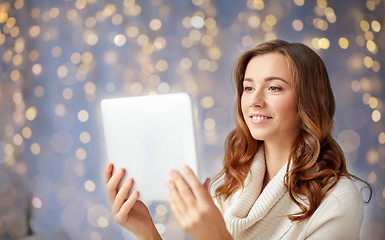 Image showing happy young woman with tablet pc at home