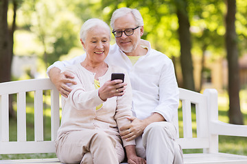 Image showing senior couple taking selfie by smartphone at park