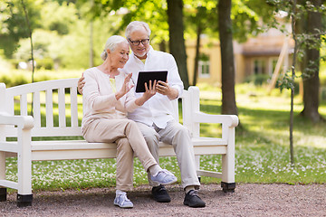 Image showing senior couple with video chat on tablet pc at park