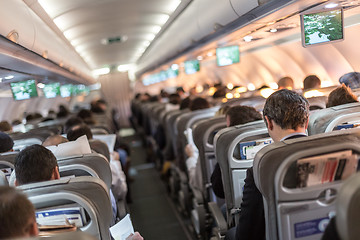 Image showing Interior of airplane with passengers on seats waiting to taik off.