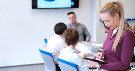 Image showing Pretty Businesswoman Using Tablet In Office Building during conf