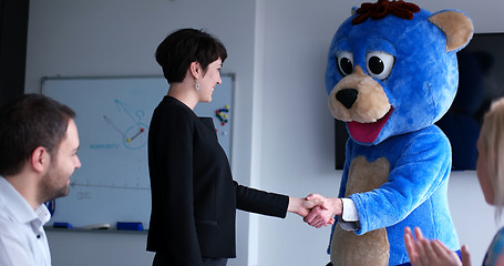 Image showing boss dresed as bear having fun with business people in trendy of