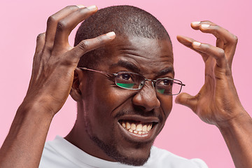 Image showing Black man holding his head in pain and depression