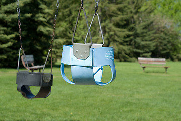 Image showing Two Empty Baby Swings