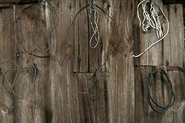 Image showing Old wooden wall with rusty objects