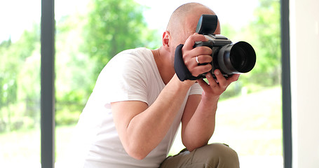 Image showing Photographer takes pictures with DSLR camera