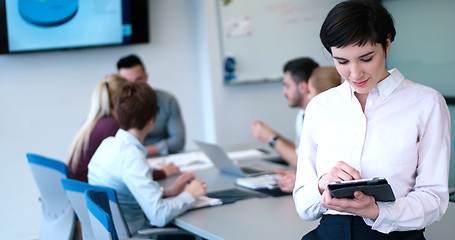 Image showing Portrait of  smiling casual businesswoman using tablet  with cow