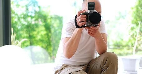 Image showing Photographer takes pictures with DSLR camera