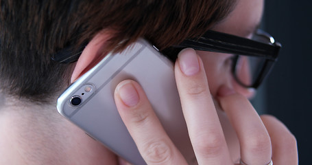 Image showing Elegant Woman Using Mobile Phone by window in office building