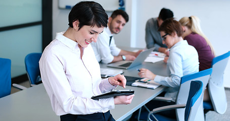 Image showing Portrait of  smiling casual businesswoman using tablet  with cow