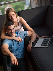 Image showing Attractive Couple Using A Laptop on couch