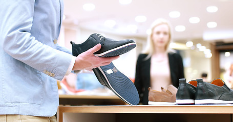 Image showing Man Chooses Shoes At Shoe Store