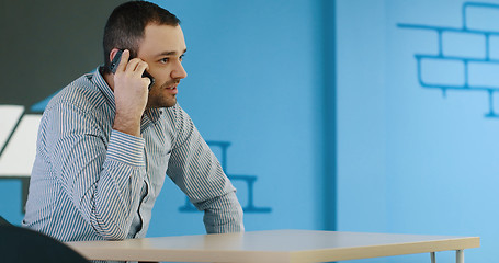 Image showing Senior businessman  using cell phone at  stratup office