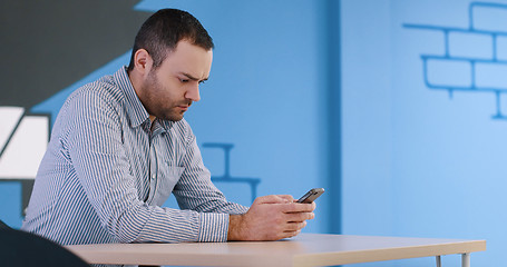Image showing Senior businessman  using cell phone at  stratup office