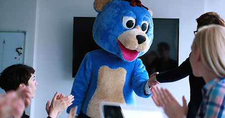 Image showing boss dresed as bear having fun with business people in trendy of