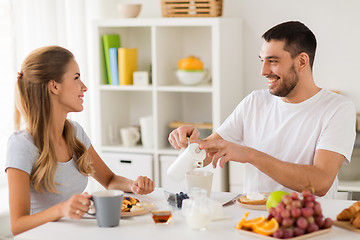 Image showing happy couple having breakfast at home