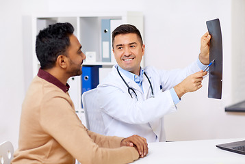 Image showing doctor with x-ray and male patient at clinic