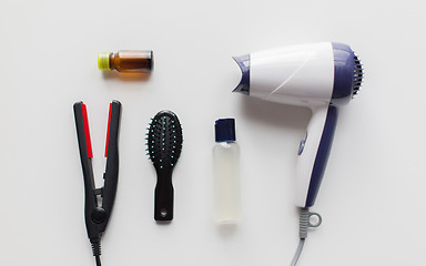 Image showing hairdryer, brush, hot styling hair spray and iron