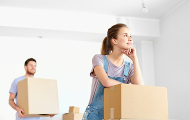 Image showing happy couple with boxes moving to new home