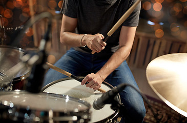 Image showing male musician playing drum kit at concert