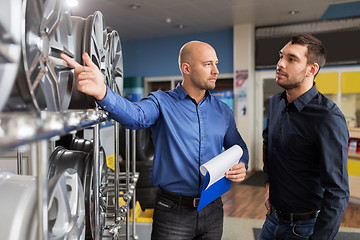 Image showing customer and salesman at car service or auto store