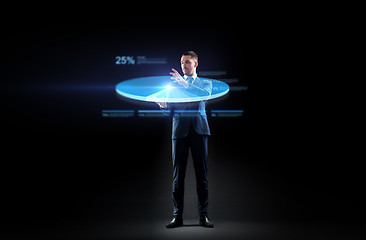 Image showing businessman in suit working with virtual pie chart