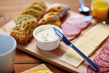 Image showing cream cheese and other food on table at breakfast