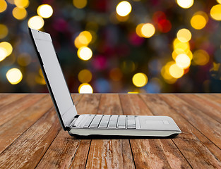 Image showing laptop computer over christmas lights