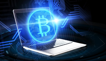 Image showing laptop computer with bitcoin hologram