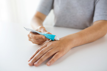 Image showing close up of hands with cream or therapeutic salve