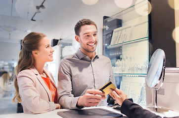 Image showing happy couple choosing engagement ring in mall