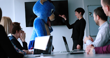 Image showing boss dresed as bear having fun with business people in trendy of