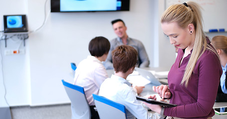 Image showing Pretty Businesswoman Using Tablet In Office Building during conf