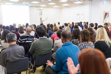 Image showing Woman giving interactive motivational speech at entrepreneurship workshop.