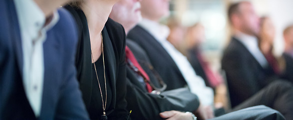 Image showing Row of business people sitting at seminar.