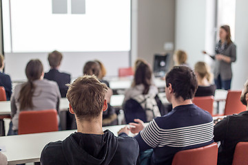 Image showing Woman giving presentation in lecture hall at university.