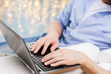 Image showing close up of man typing on laptop keyboard