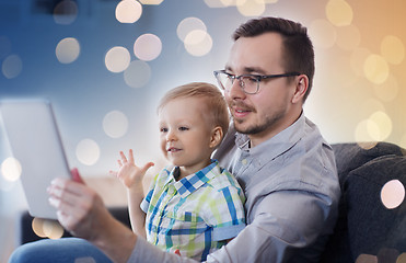 Image showing father and son with tablet pc playing at home