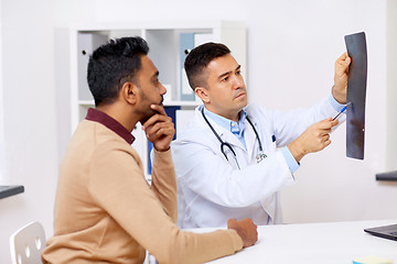 Image showing doctor with x-ray and male patient at clinic