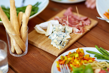 Image showing blue cheese and breadsticks on table