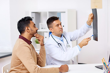 Image showing doctor with x-ray and male patient at clinic