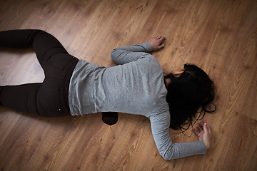 Image showing dead woman body in blood on floor at crime scene